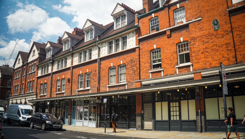 Old Spitalfields Market exterior – Red‑brick Victorian façade of Old Spitalfields Market under summer sky.