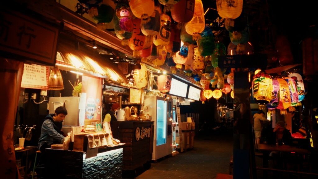 Shennong Street at night with glowing lanterns and open bars creating magical atmosphere